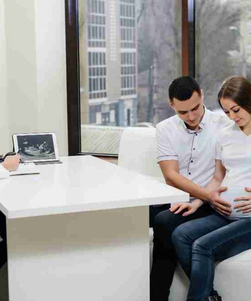 A woman having an open conversation with her OB/GYN about maternal health and wellness.